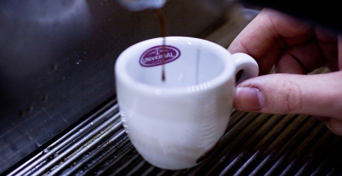 Espressokaffe hälls upp i kopp.